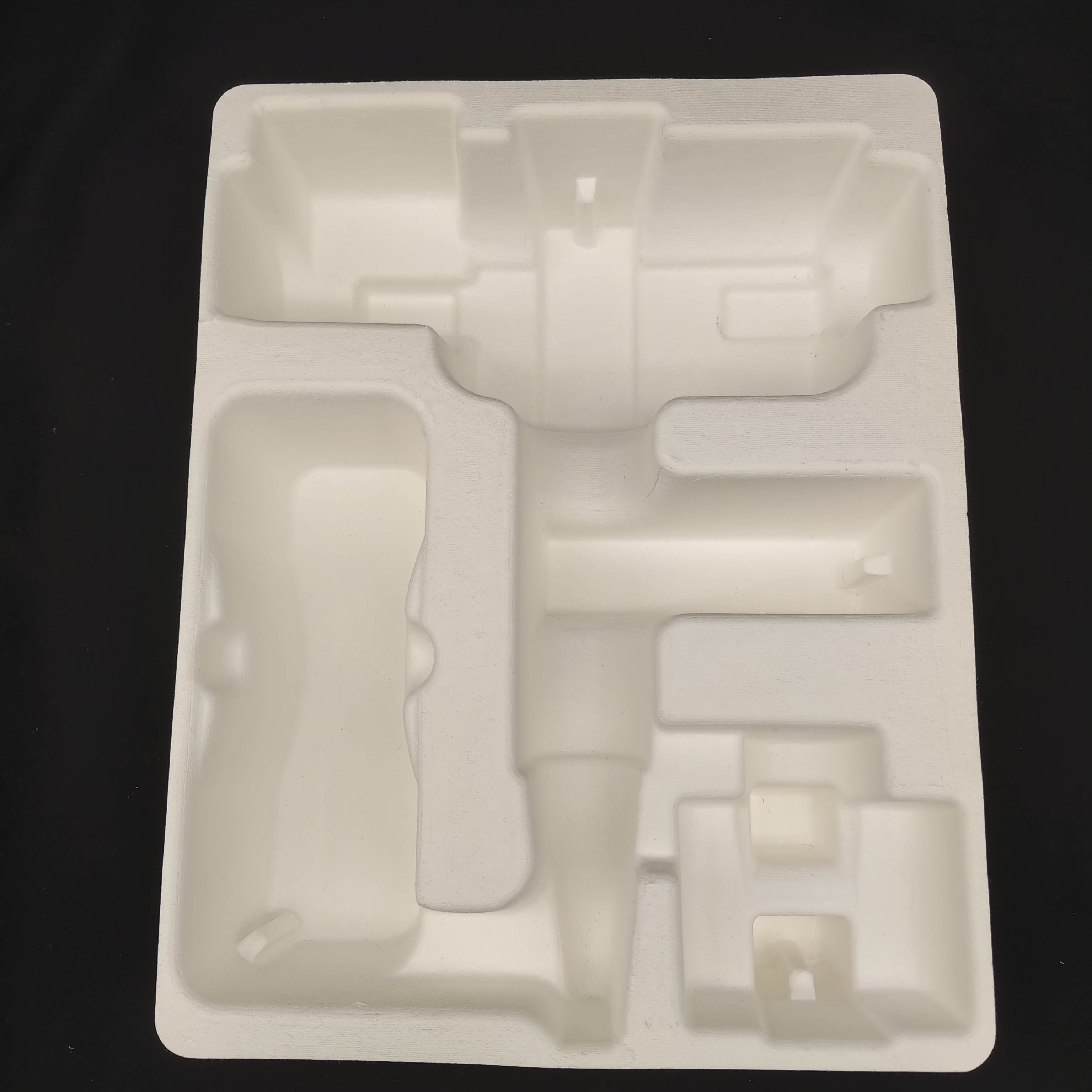 OEM manufacturers customize pulp molded packaging bases for small household appliance fascia guns. These are made of white plant fibers through dry