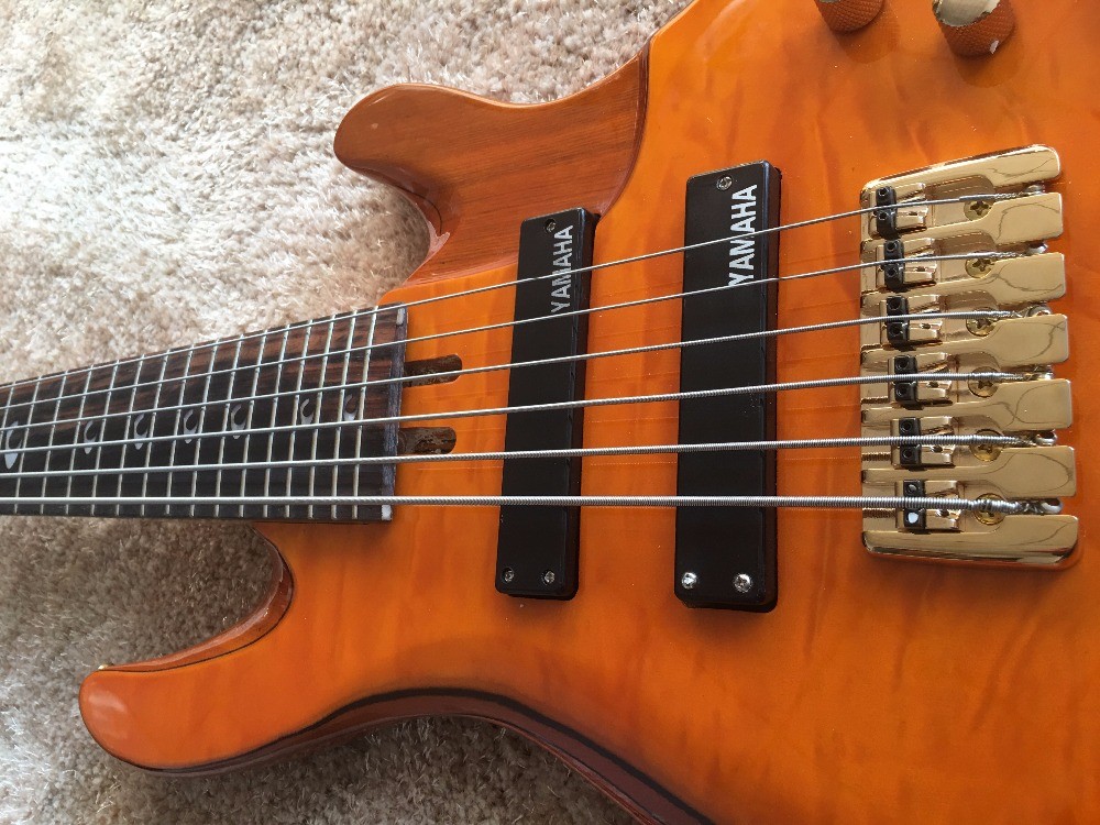 6 string bass guitar JP2 yellow quilted maple body back and front Active pickups Golden bridges and tuner Alder with ebo