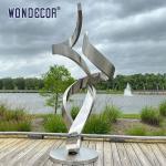 Large forged metal shaped twisted geometric stainless steel sculpture in the