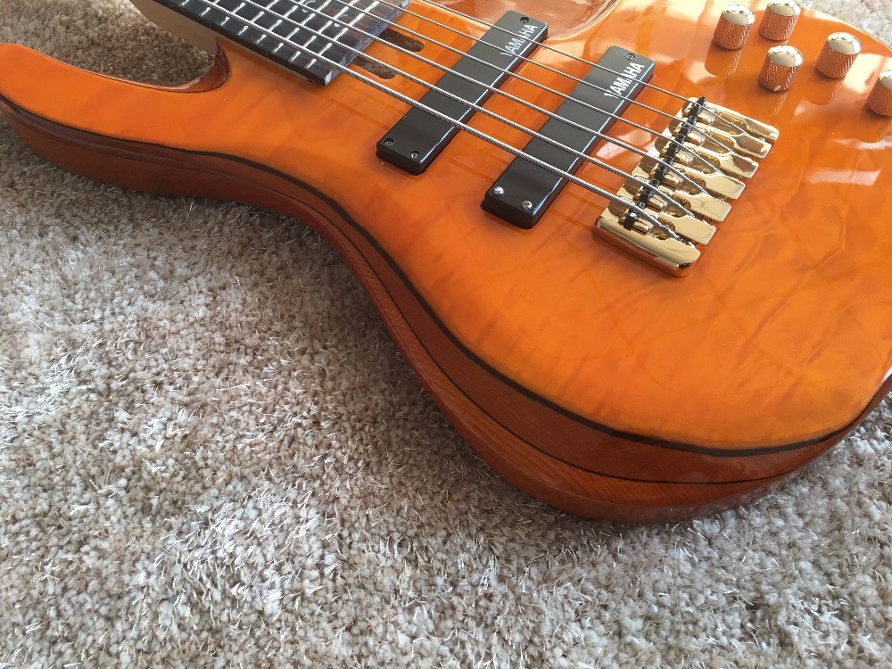 6 string bass guitar JP2 yellow quilted maple body back and front Active pickups Golden bridges and tuner Alder with ebo