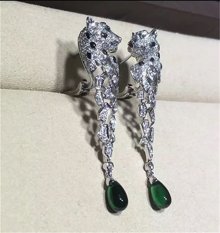 C Cheetah Earrings - showing the charm of courage, naughty or docile .310 round bright cut diamonds, emerald and onyx.