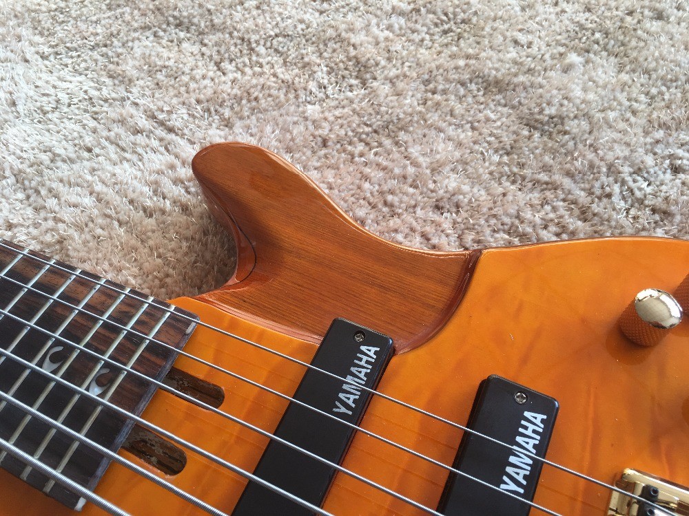 6 string bass guitar JP2 yellow quilted maple body back and front Active pickups Golden bridges and tuner Alder with ebo