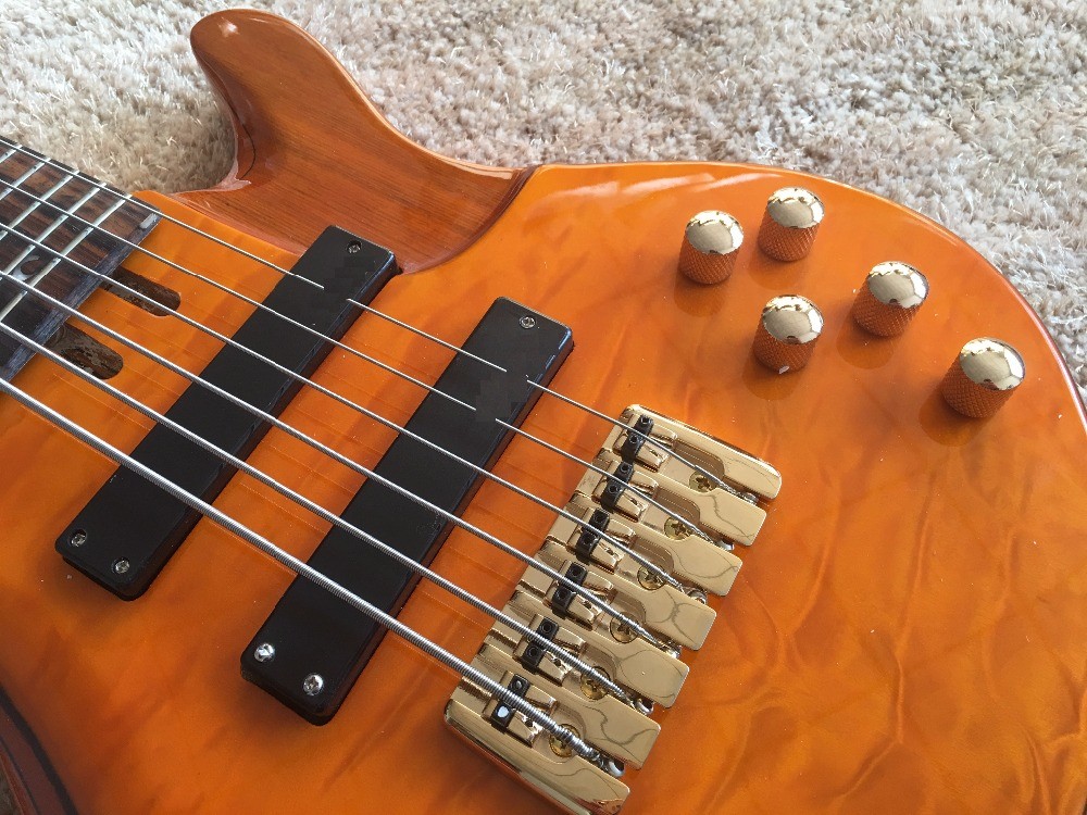 6 string bass guitar JP2 yellow quilted maple body back and front Active pickups Golden bridges and tuner Alder with ebo