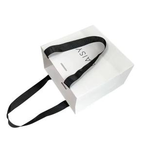 Quality Embossing Ribbon Handle Cosmetic Paper Bags White Paper Carrier Bags wholesale