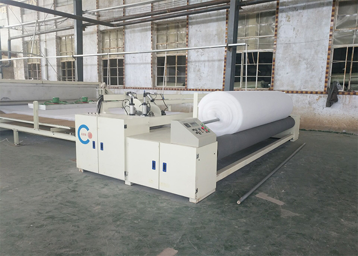NON-WOVEN ROLL AND CUT MACHINE