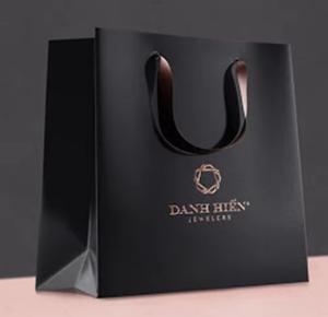 Quality Luxury Black Paper Apparel Packaging Gift Shopping Bag Customized Branded Logo wholesale