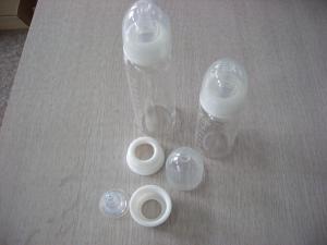 Quality 9oz Baby Glass milk Bottle with Plastic Packaging and Liquid Silicone Nipple wholesale