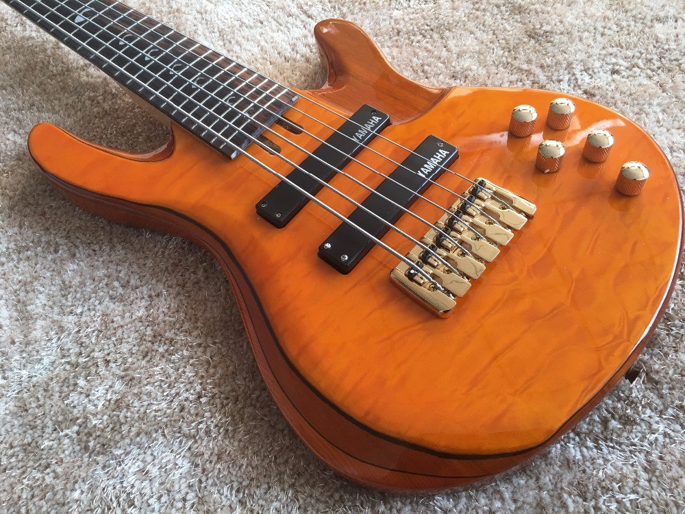 6 string bass guitar JP2 yellow quilted maple body back and front Active pickups Golden bridges and tuner Alder with ebo