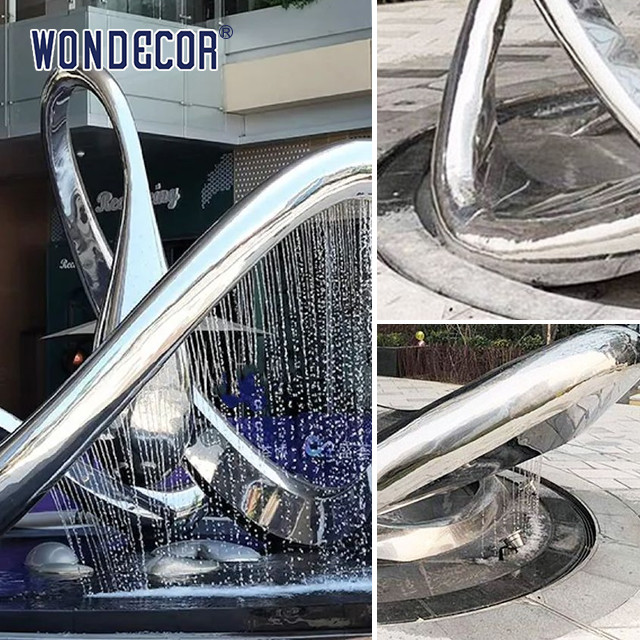 Large geometric circular fountain stainless steel sculpture in the square